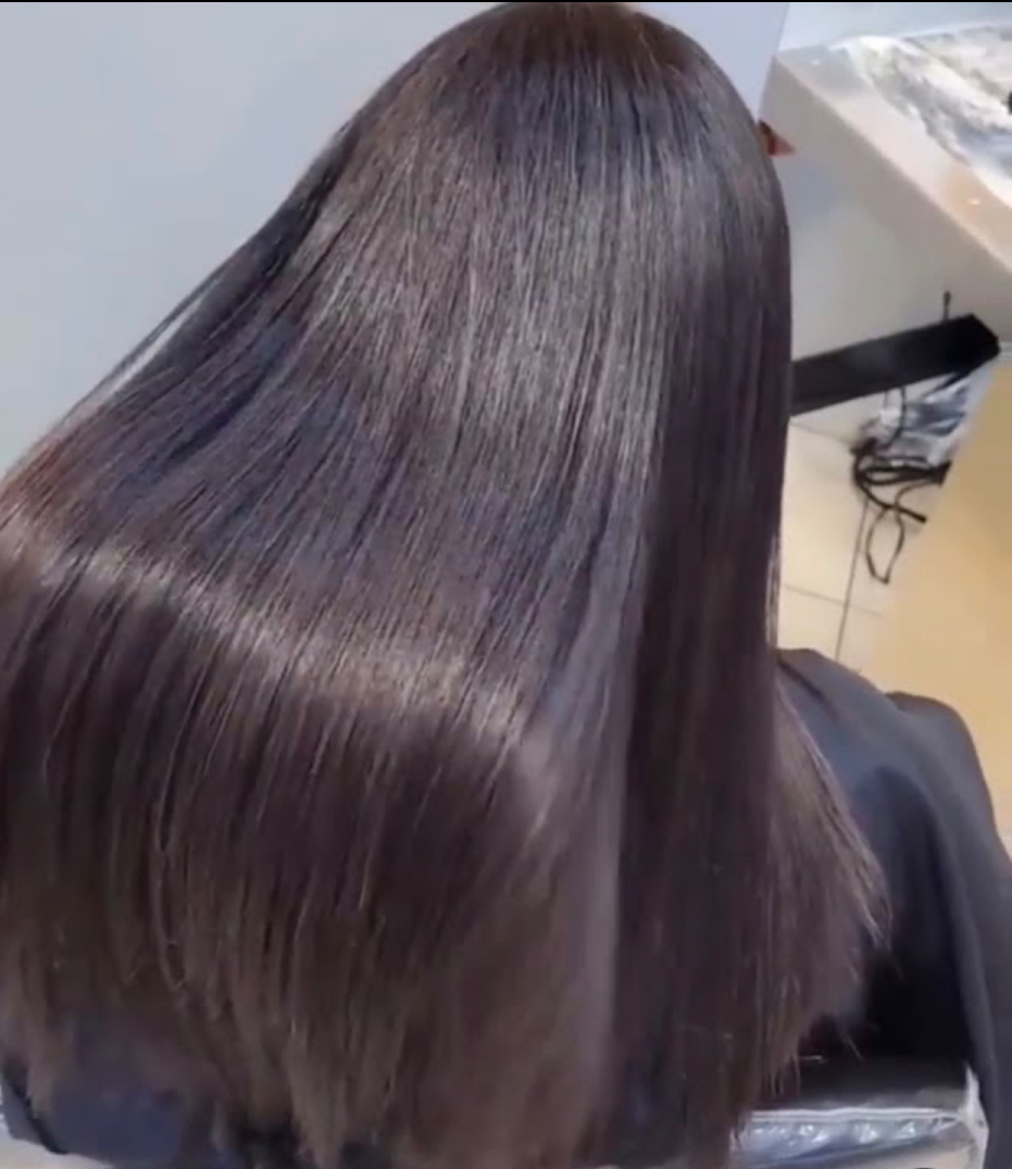Glossy, freshly colored straight hair styled at the studio