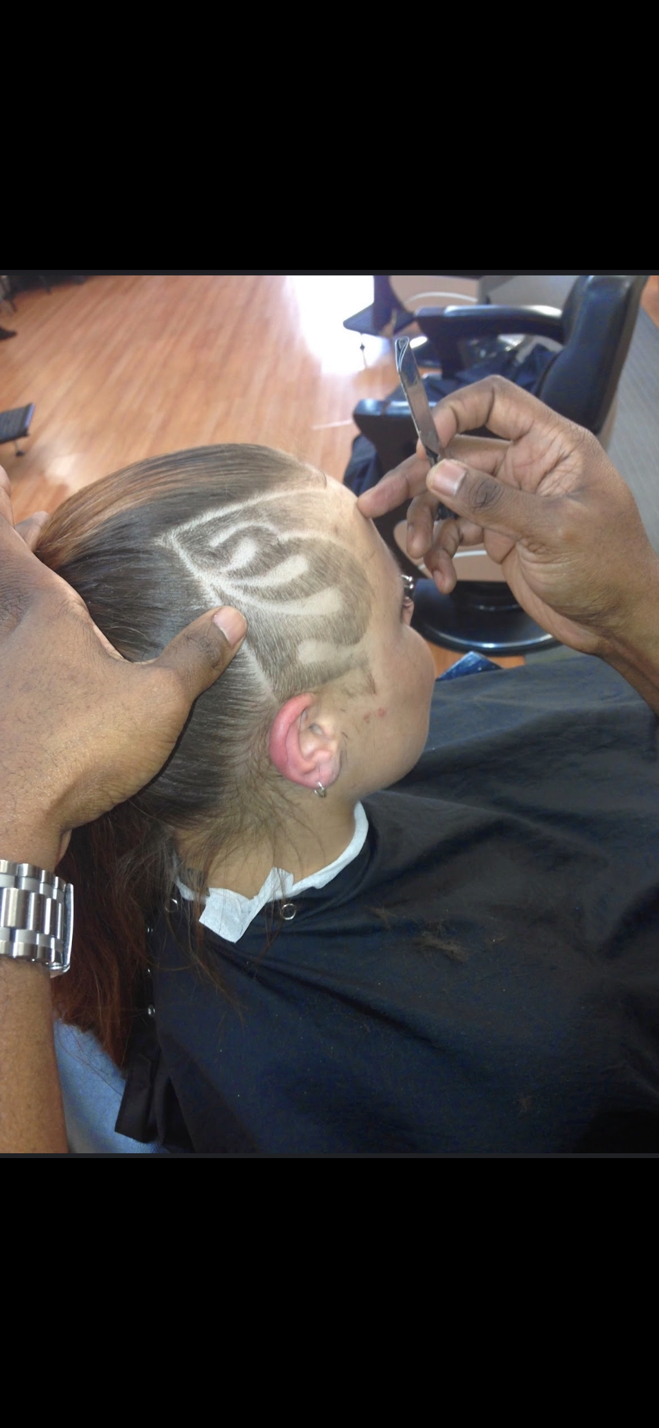 Custom hair design and color carved into a fade