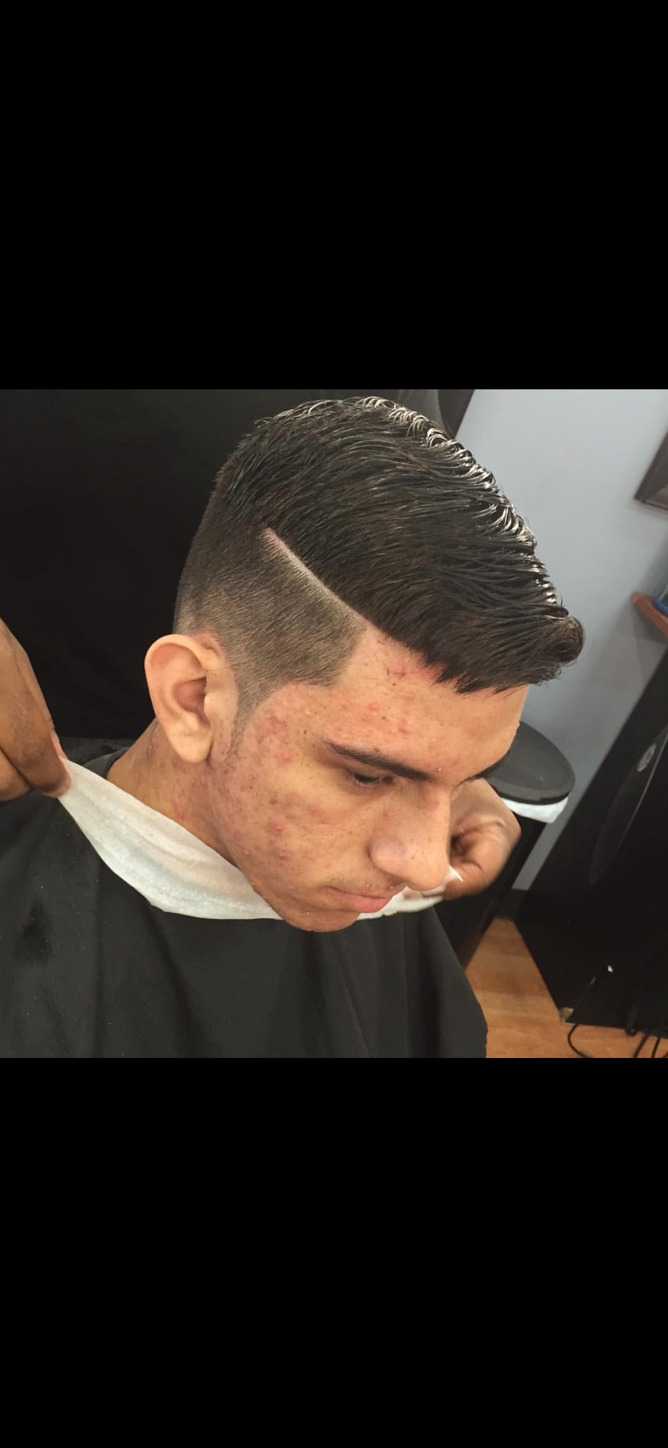 Textured pompadour with a sharp hard-part line-up